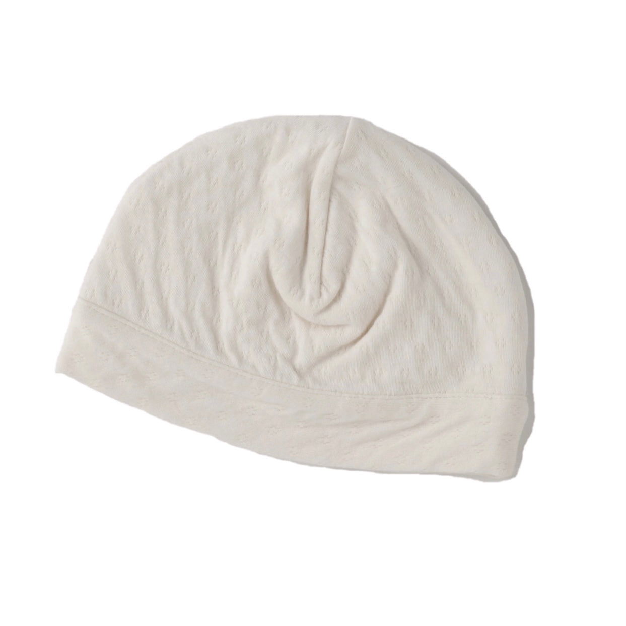 cream color pointelle double layered skull cap for newborn. 100% organic cotton.
